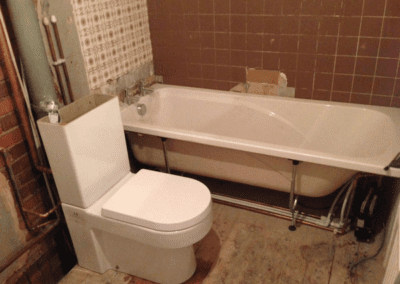white bath and toilet, bathroom plumbing in progress